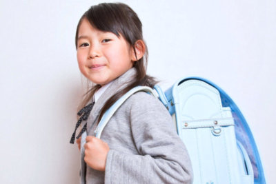 kid with her bag smiling