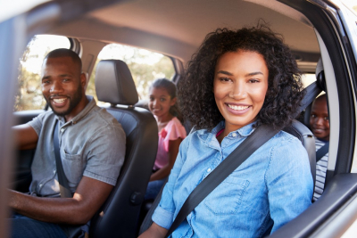 kids on a car smiling