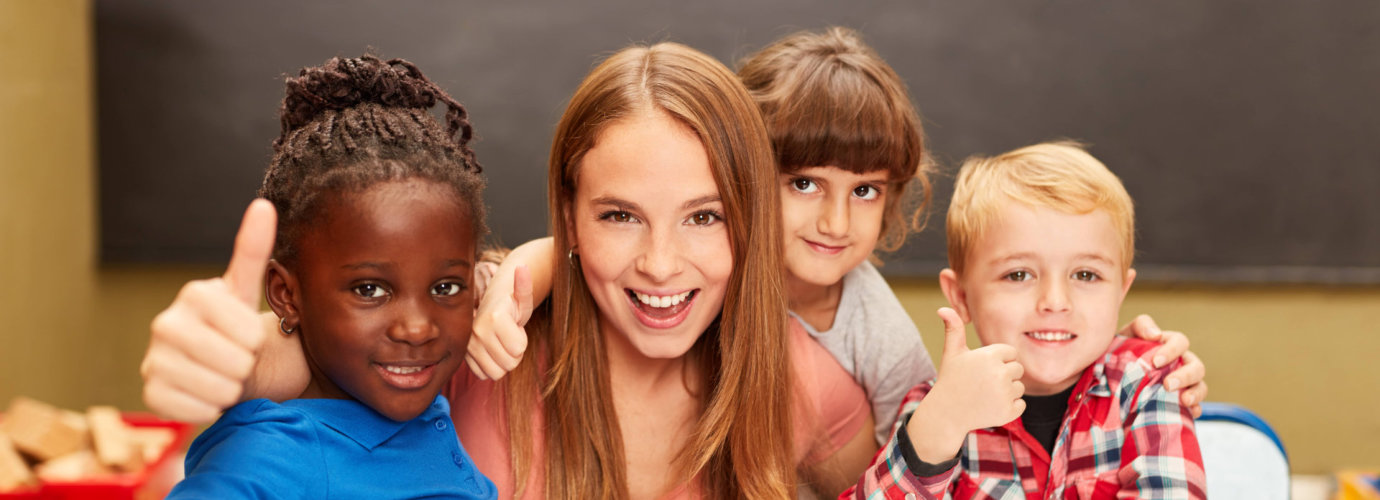 attractive teacher with her students smiling