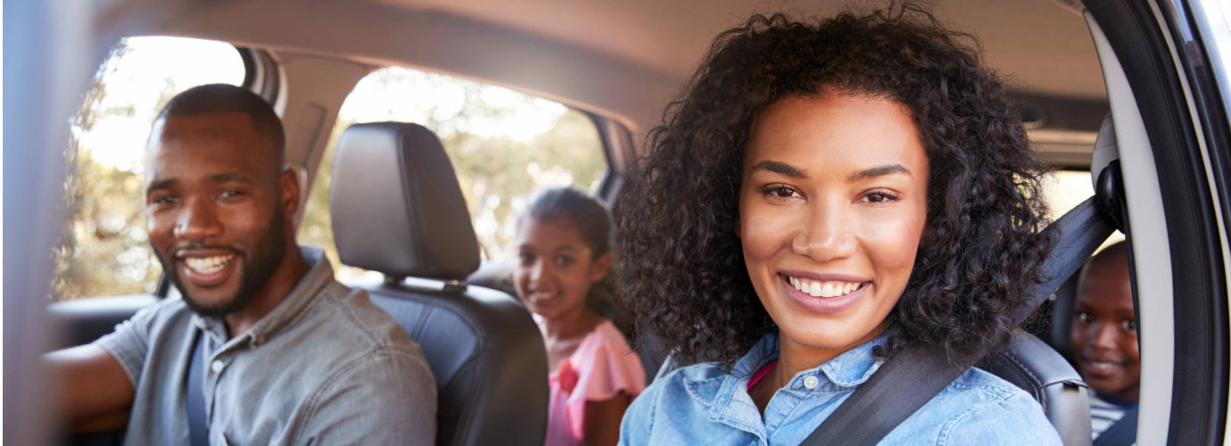 kids on a car smiling