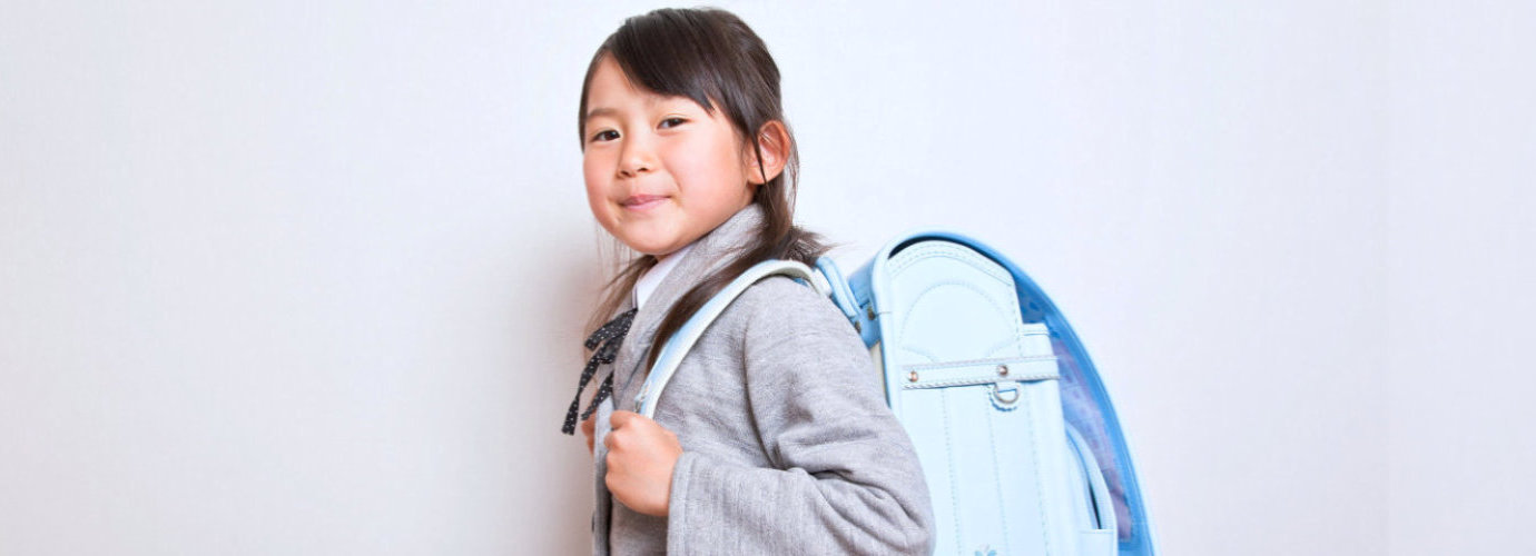 kid with her bag smiling